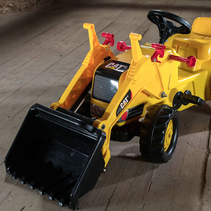 Lifestyle image of the front loader in the down position on the CAT Kid Tractor.