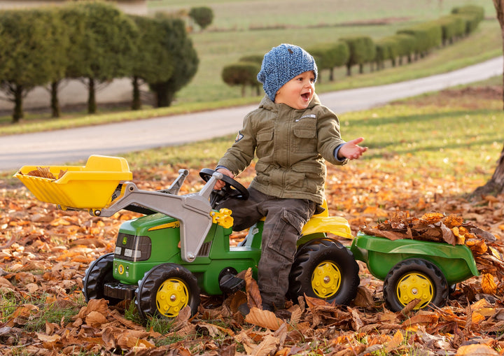 Child riding on john deere blow mold resin vehicle with front loader and trailer