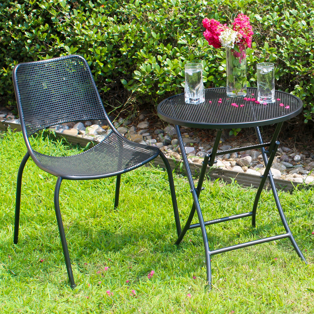 Lifestyle shot of wrought iron foldable table with chair