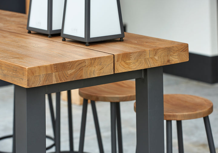 With its powder coated construction and 100% Indonesian SVLK certified teak tops, the Nevada Bar Set is a true work of art.  The combination of durable aluminum frame and warm robust teak gives it an eye-catching industrial look that will surely grab the attention of the most disconcerting critic.