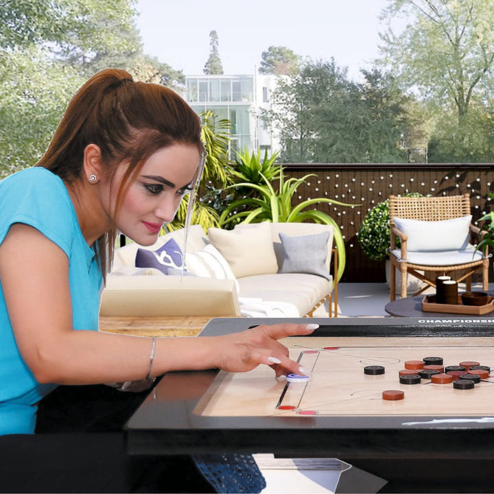 women playing on the STAG Championship Carrom Board