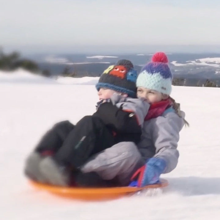Two children sitting on UFO wok sled made from resin