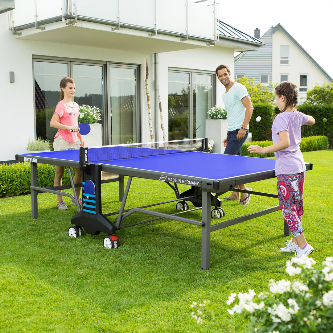 Family fun on a KETTLER Table Tennis Table in the backyard.