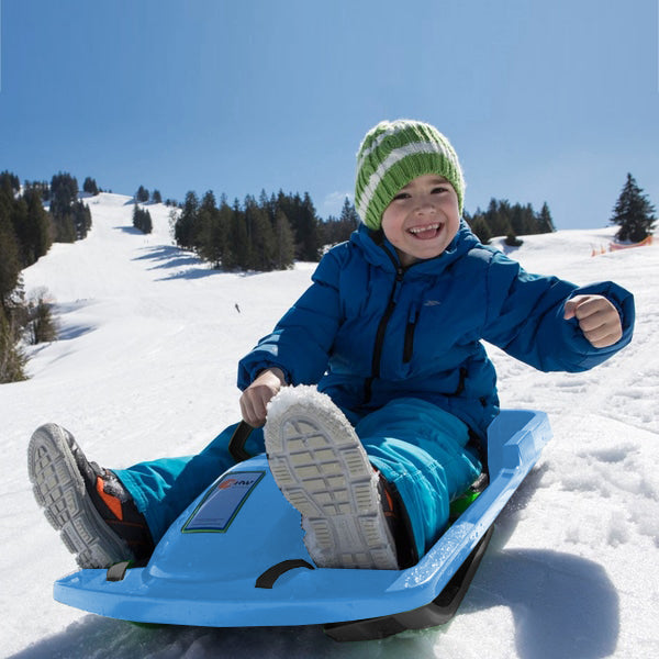 Young boy sliding down a snowy hill on a KETTLER sled.