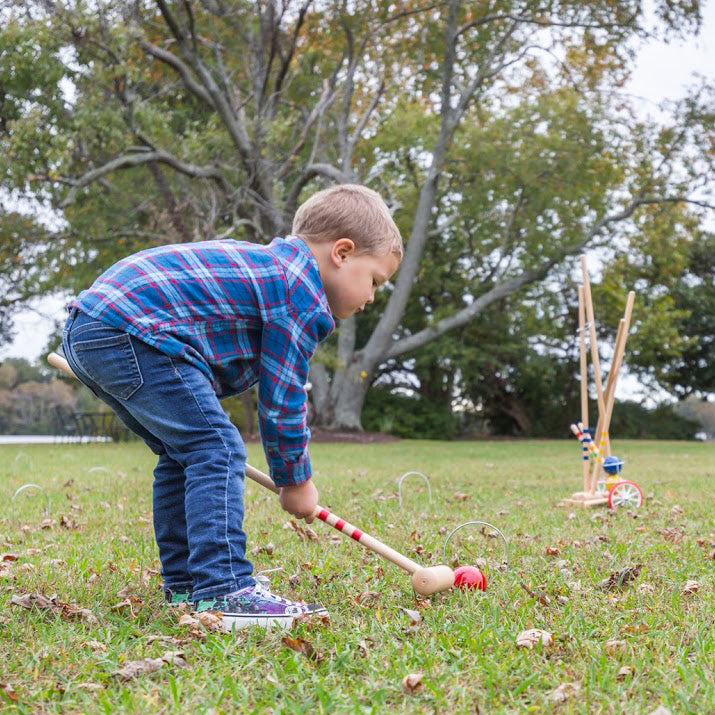 Child playing with 4 Player Childrens Croquet Set