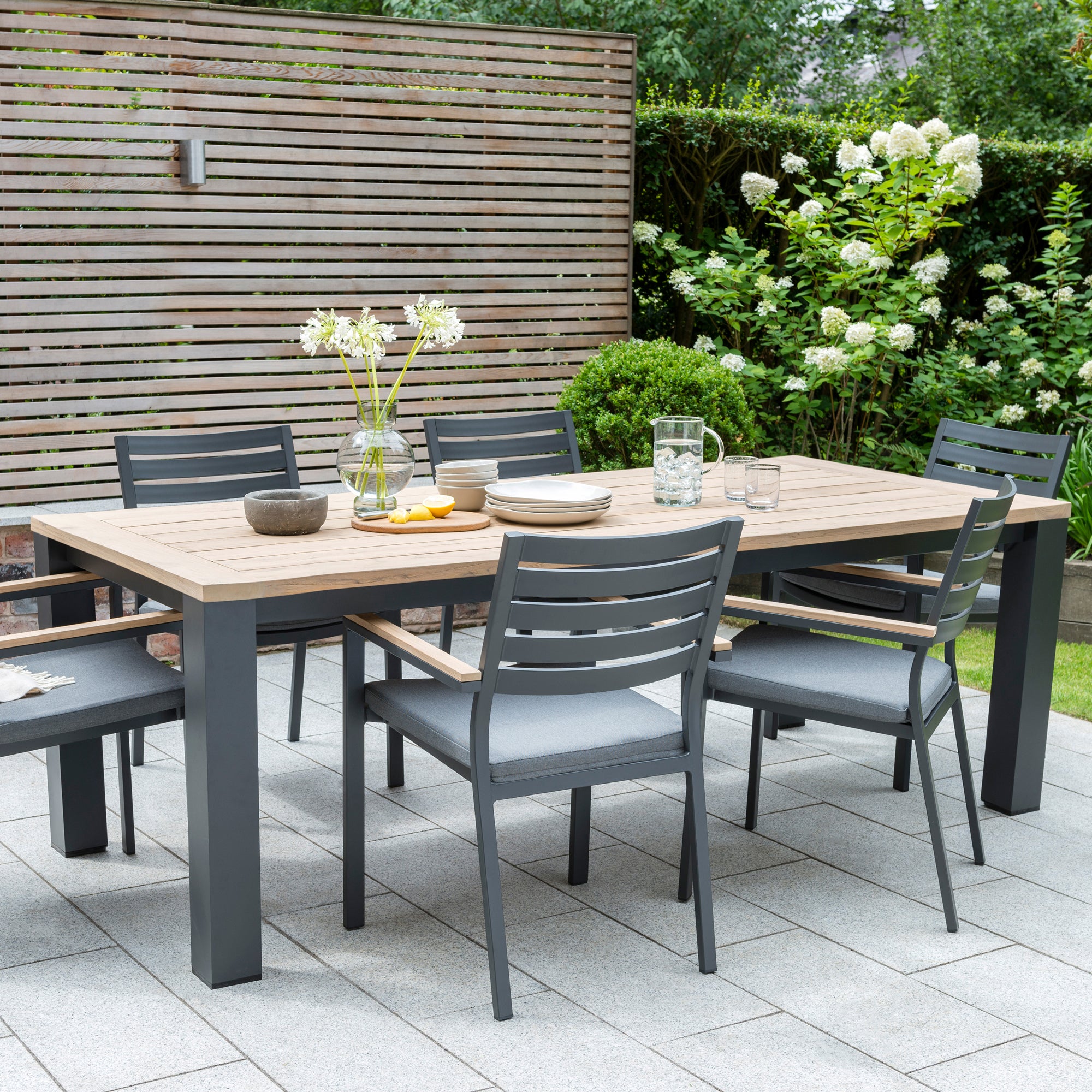 Elba Dining Collection with aluminum frame and teak table top and accents