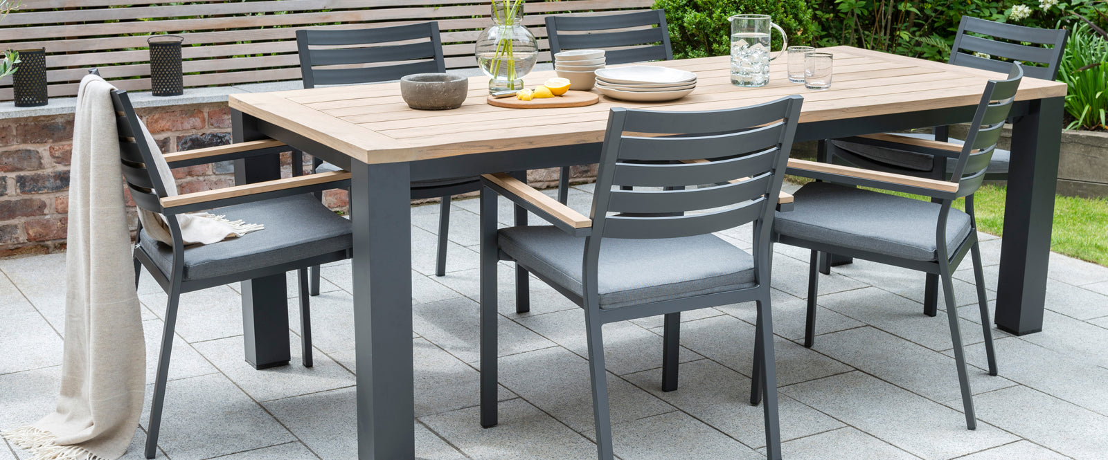 Elba Dining Collection with aluminum frame and teak table top and accents
