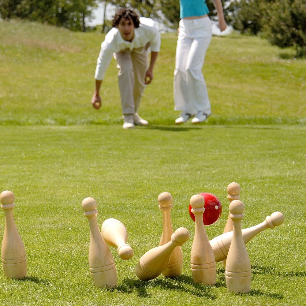 Couple playing skittles, lawn bowling
