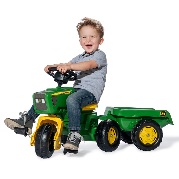 Child riding on three wheeled john deere tractor with sound effects