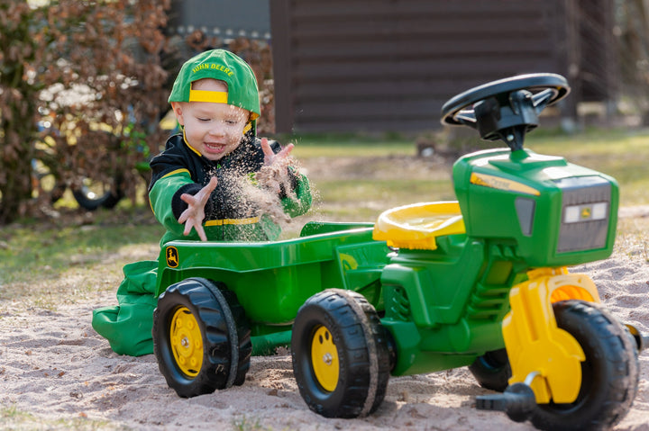 Toddler loading sand into trailer of JD blow molded resin tractor