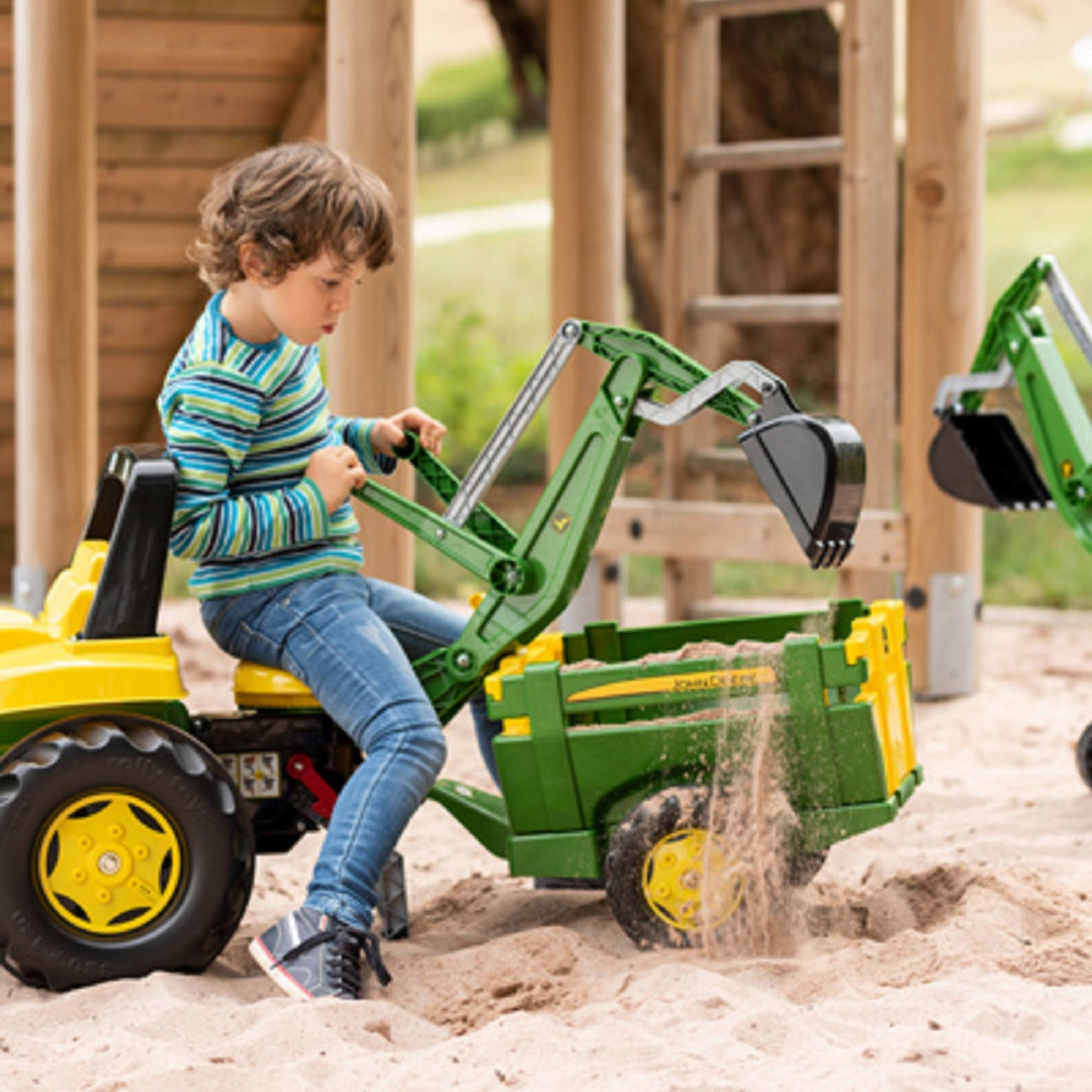 Made in Germany john deere trailer being loaded by child with sand from a ride on digger