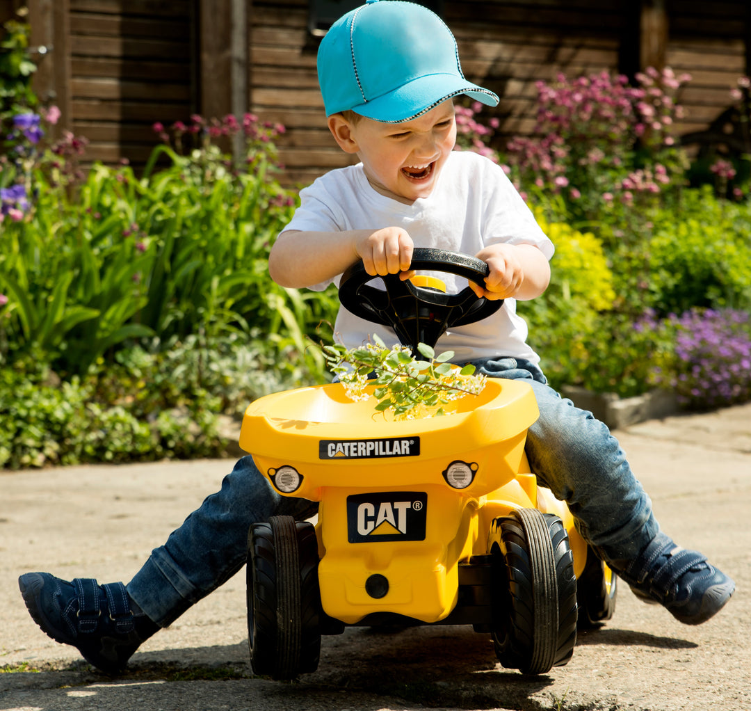 Child riding on foot to floor resin vehicle with load in front loader