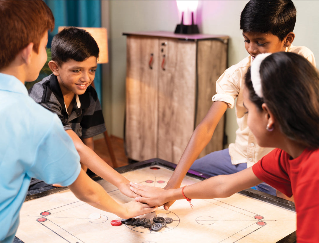 children playing on the STAG Championship Carrom Board