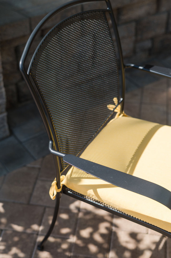 Close up of Henly Arm chair with wrought iron arm rests