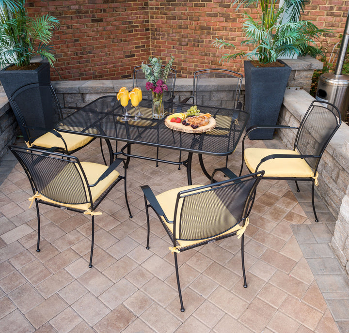 Lifestyle shot of 7 piece wrought iron henly set with 6 chairs and rectangular table