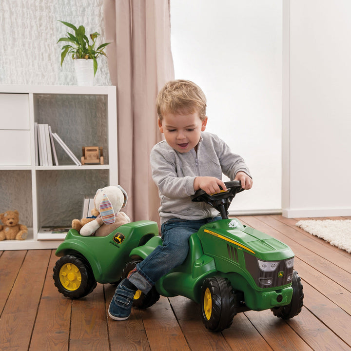 Lifestyle Photo of young boy riding on the John Deere Mini Trac with the trailer attached.