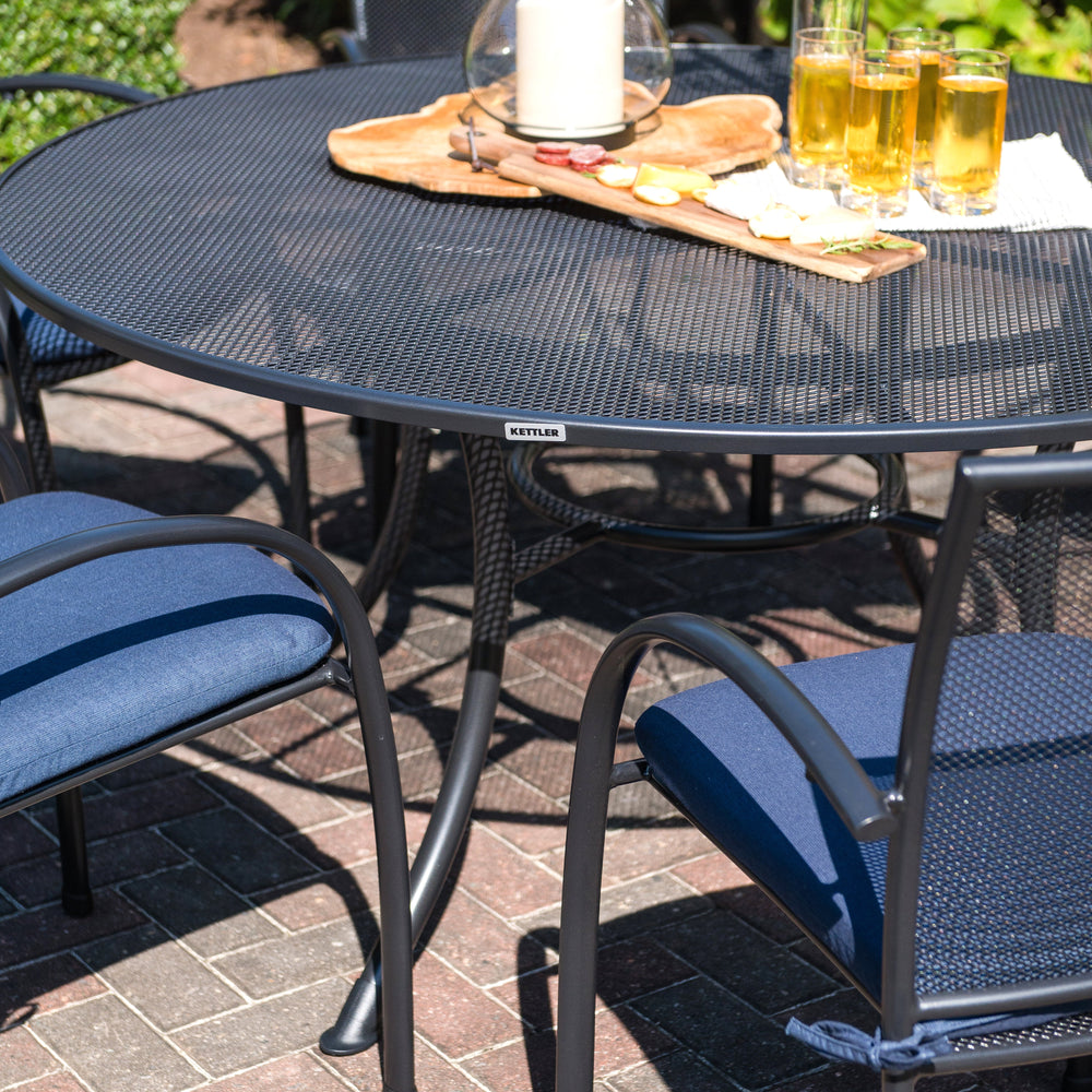 Closeup of top of the KETTLER 60" round wrought iron mesh table