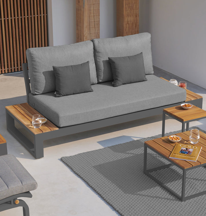 The fresh, laid-back style of the Soho Lounge Set is sure to transform your outdoor living space into a peaceful sanctuary. Share an evening of gathering and fun while relaxing in the open-ended loveseat with built in FSC certified teak end tables and ultra-comfortable all-weather cushions.
