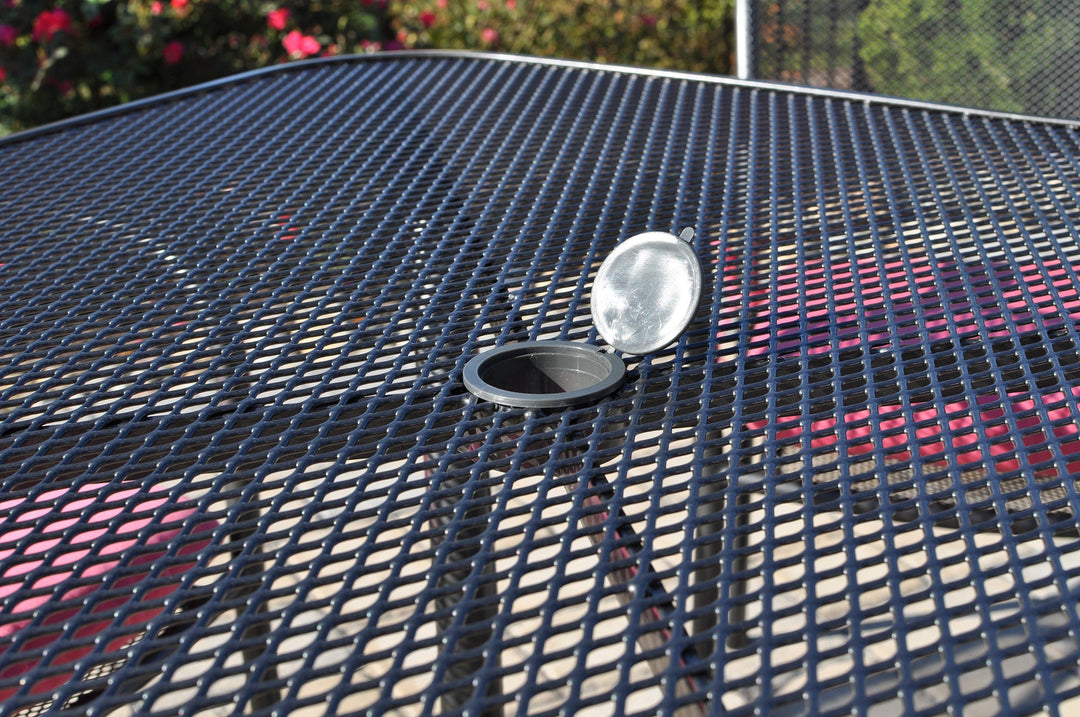 Closeup of the umbrella hole on the KETTLER mesh wrought iron table