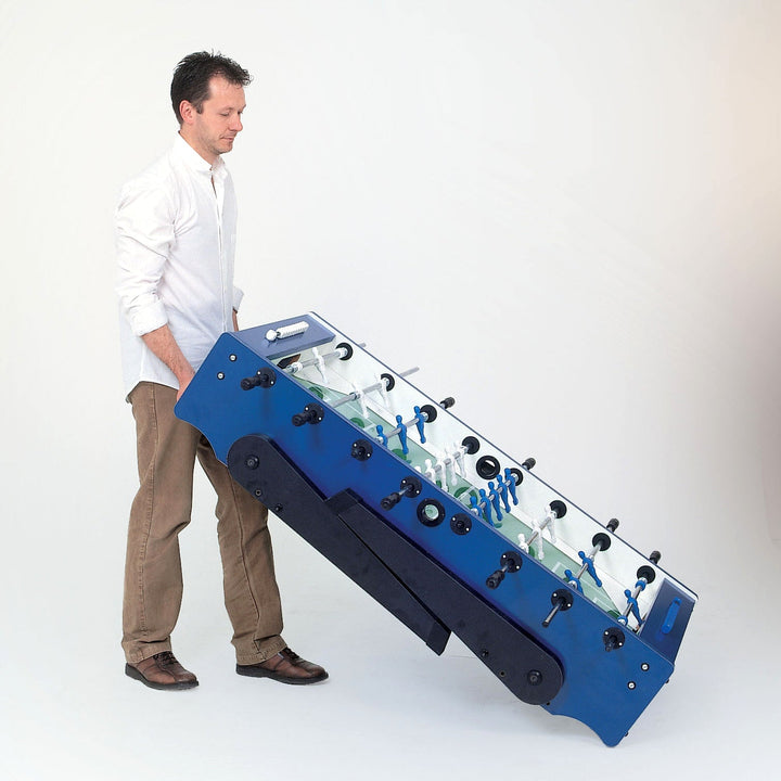 FOLDY Evolution Indoor Foosball Table folded and being pushed on wheels by man